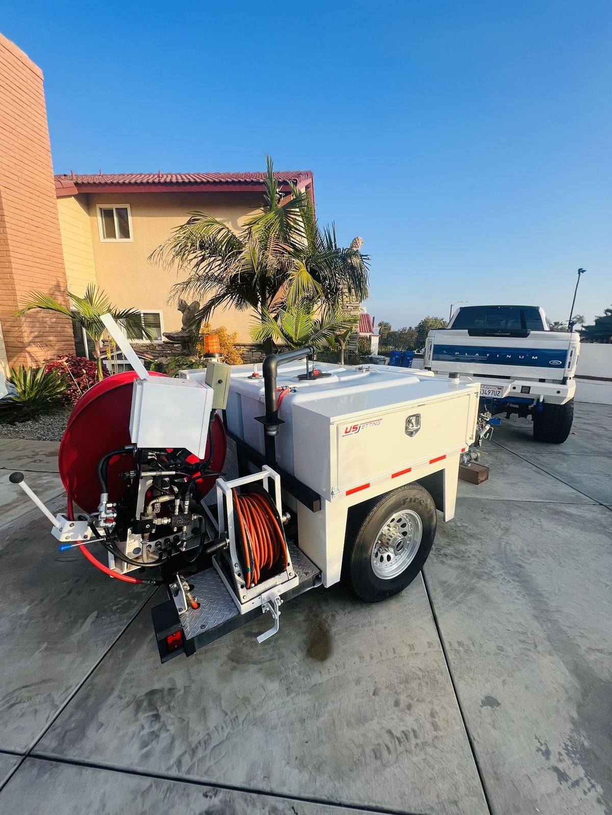Viper's US Jetting trailer-mounted hydro jetter on a residential job