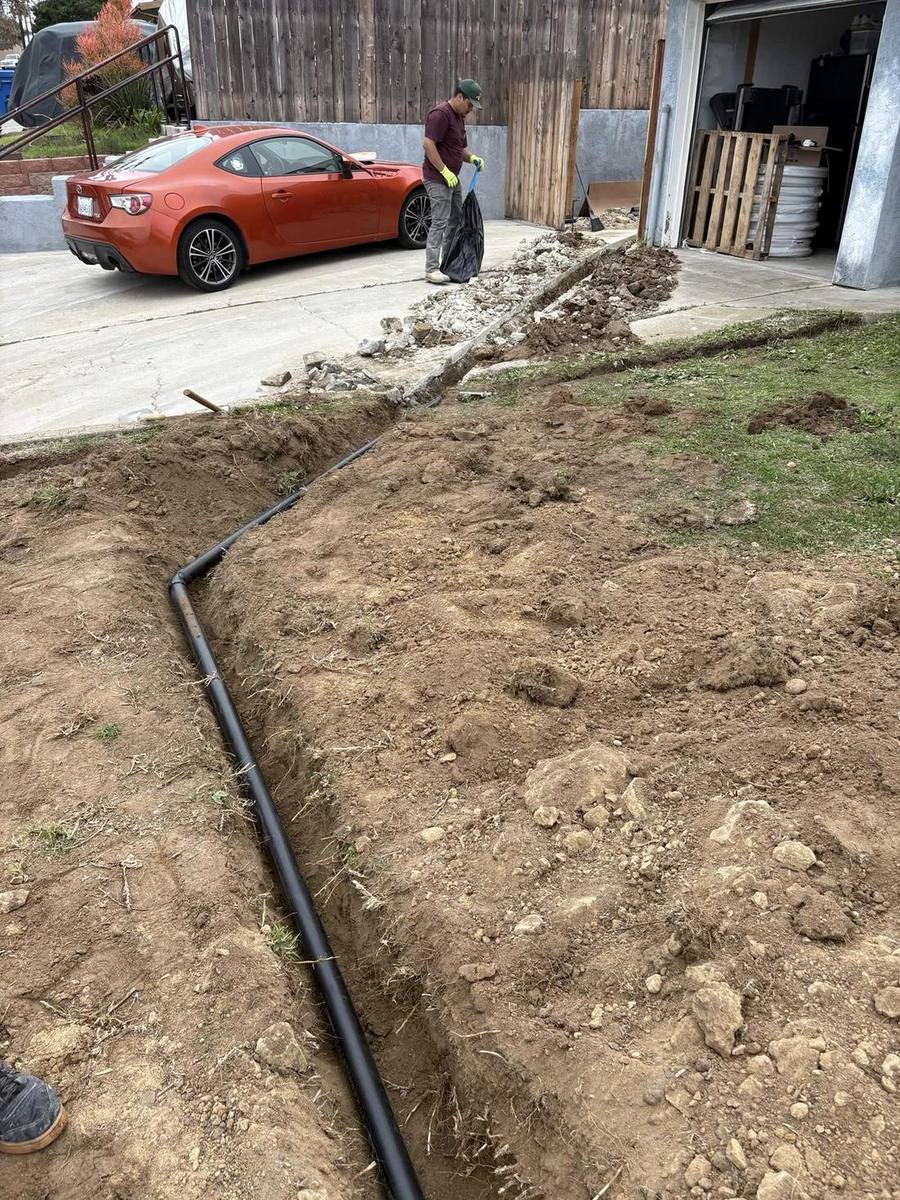 New sewer lateral pipe laid in a trench from house to street